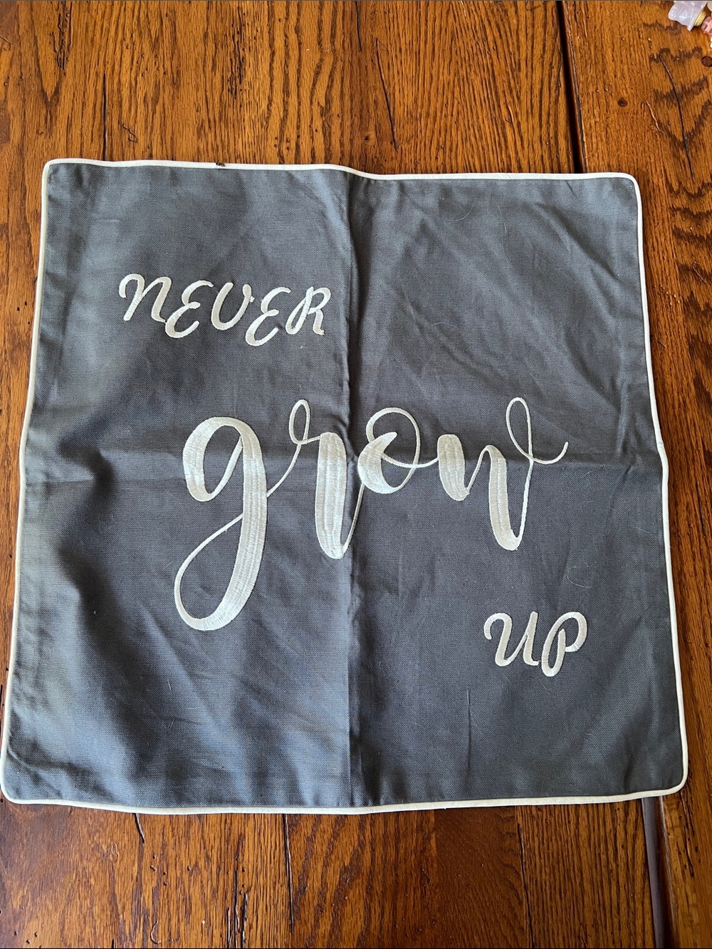 Embroidered Gray Decorative Pillow Cover with Script "Never Grow Up”